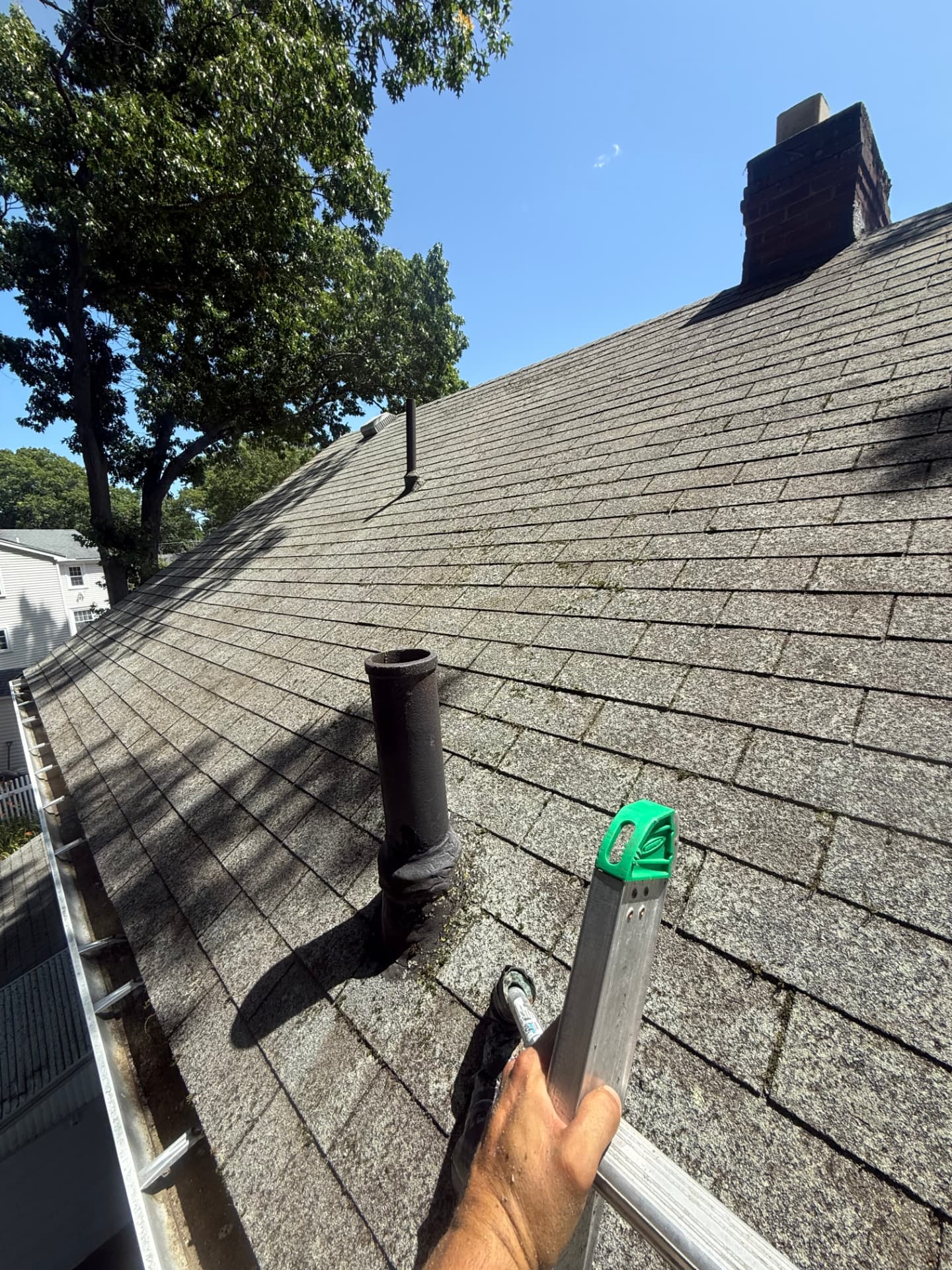 The same roof cleared of moss with the gutter emptied after professional washing